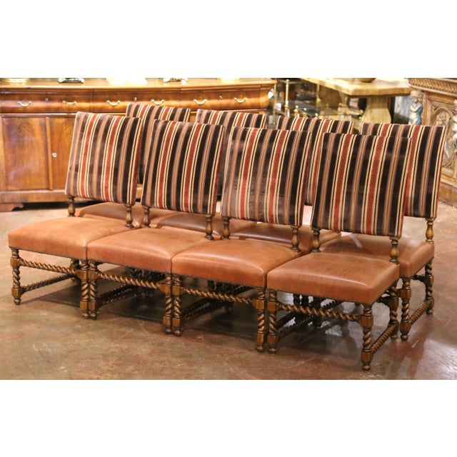 A handsome set of ten vintage dining chairs combining the architectural character of the Louis XIII style with rich, warm...