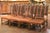 A handsome set of ten vintage dining chairs combining the architectural character of the Louis XIII style with rich, warm...