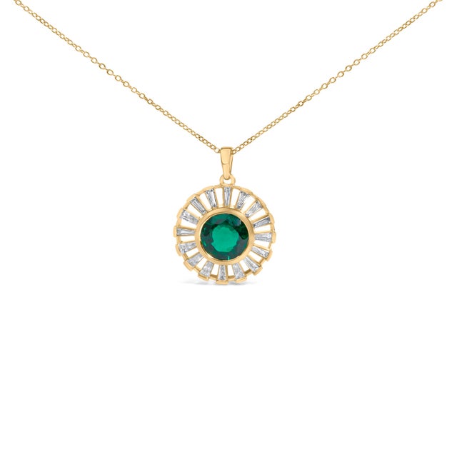 A luminous talisman of contrast and clarity, this round medallion draws the eye to a 9 mm lab-created emerald, bezel set...