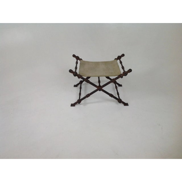 Modern accent iron ottoman with suede seat. The ottoman is made of solid iron with a distressed aged finish. The ottoman...