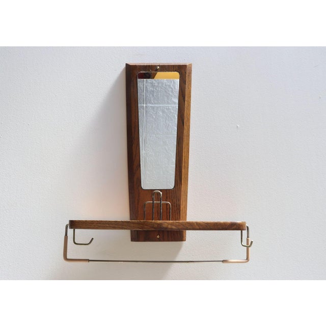 Stylish, functional wall valet with mirror, ca. 1950s, USA. Composed of an English Chestnut-framed mirror and shelf with...