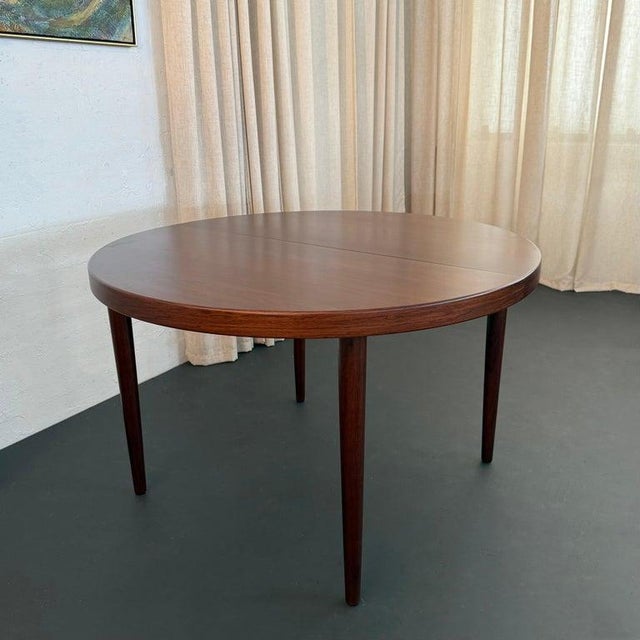 This simple yet elegant rosewood extension dining table was designed by Kai Kristiansen for the fine furniture makers...
