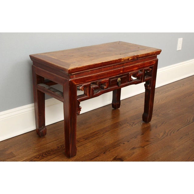 A 19th century Chinese elmwood ming style low table. This side table epitomizes the seamless merger of form and function...