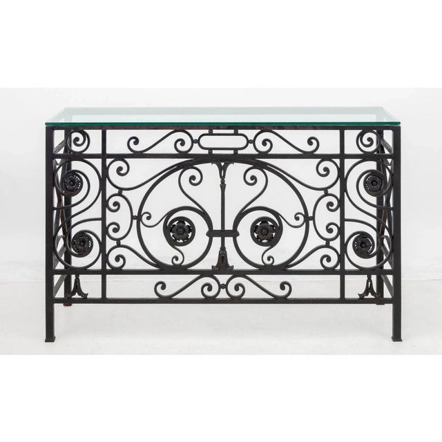 Beveled Glass-Topped Black Patinated Wrought Iron Console Table, with scrolling motif. 35.75" H x 58.25" W x 18" D....