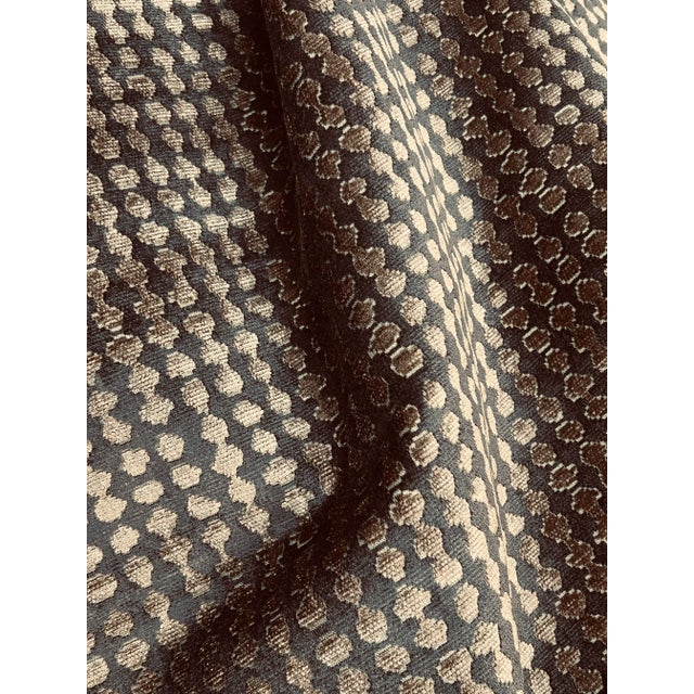 A contemporary medium-scale design of what appears to be irregular ½” chocolate dots align in rows on a cooking sheet...