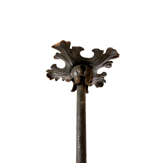 Wrought iron chandelier. It has handmade flower shape decorations and light bulbs placed at their center, purple silk and...