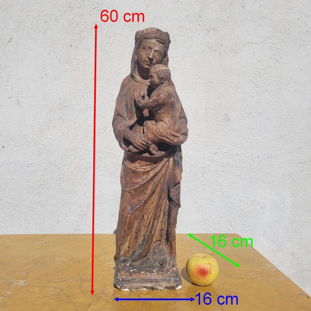 A touching sculpture in the round depicting the Virgin and Child, carved from soft limestone, dating from the 15th...