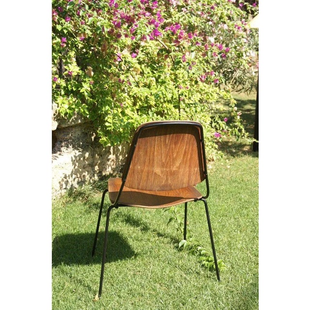 This chair was designed by Augusto Bozzi in the 1950s. It was manufactured by Saporiti Italia in the 1970s. It features a...