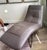 Roche Bobois ARIOSO sculptural chaise longue designed by Zeno Nugari, Upholstered in subtle taupe-gray leather with...
