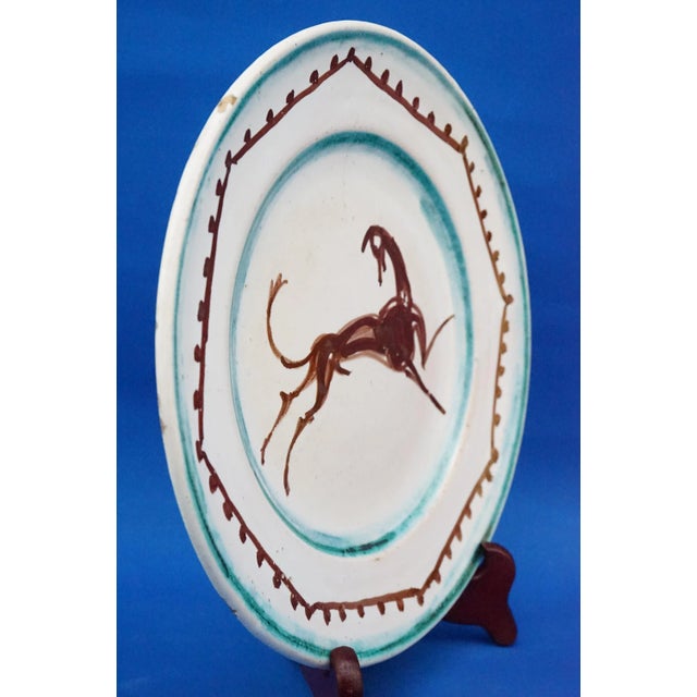 Description of the object: Glazed and enameled ceramic plate, entirely decorated by hand, with a beautiful central...