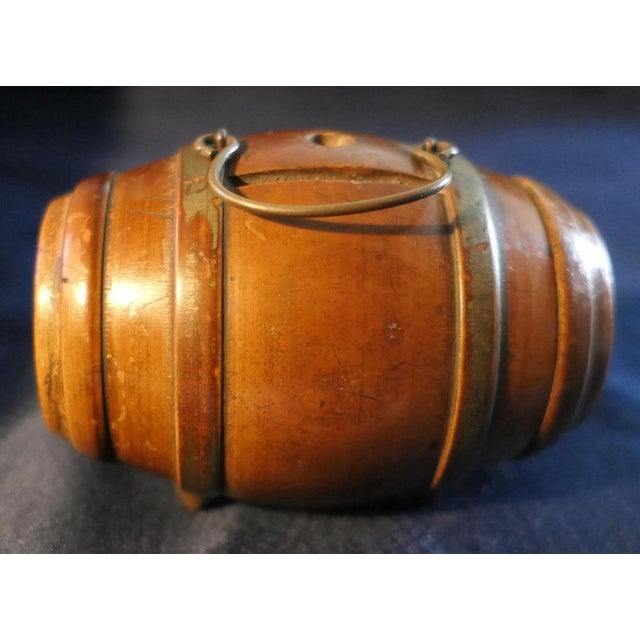 A fine 19th century treen money box, made in fruitwood with brass feet and handle, the money box is in good condition for...
