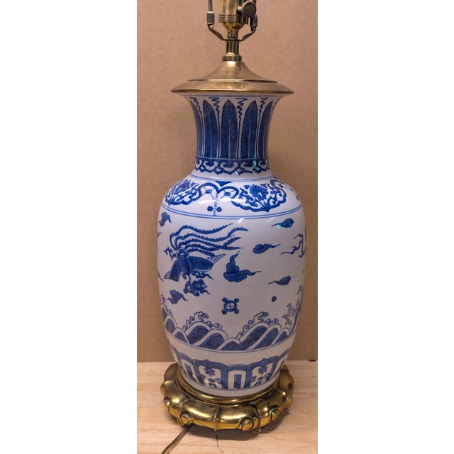 Blue and white Asian style ceramic/porcelain with brass(?). Approx. 7.5”w x 34”h (with finial) Does not include shade....