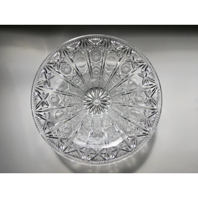 An early 20th century heavy glass bowl with an elaborate design which catches the light in a striking manner. It is...