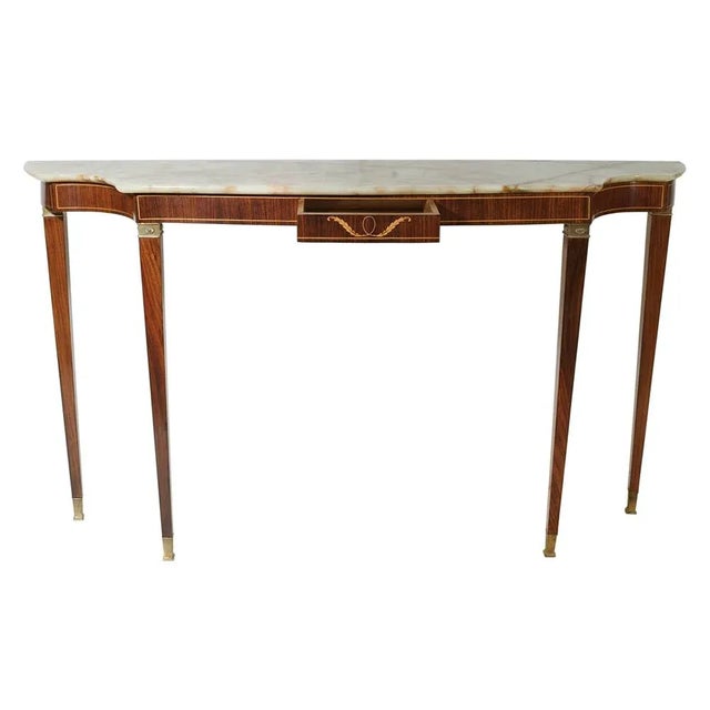 An elegant console table, one center drawer, marble top, tapered feet with brass details. Designed by architect Paolo...
