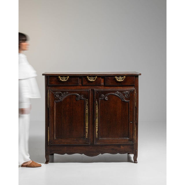 This piece presents as a piece, distinguished by dark aged walnut, brass hardware accent. Originating in France during...