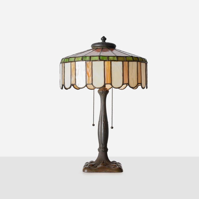 Art Nouveau Slag Glass Table Lamp with Metal Overlay United States, c1920s American slag glass table lamp in the Art...