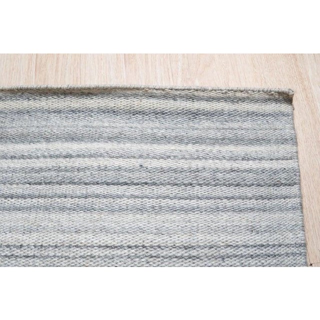 This hand woven rug features a blend of wool and viscose materials, constructed in a flatweave Kilim style. Presented in a...