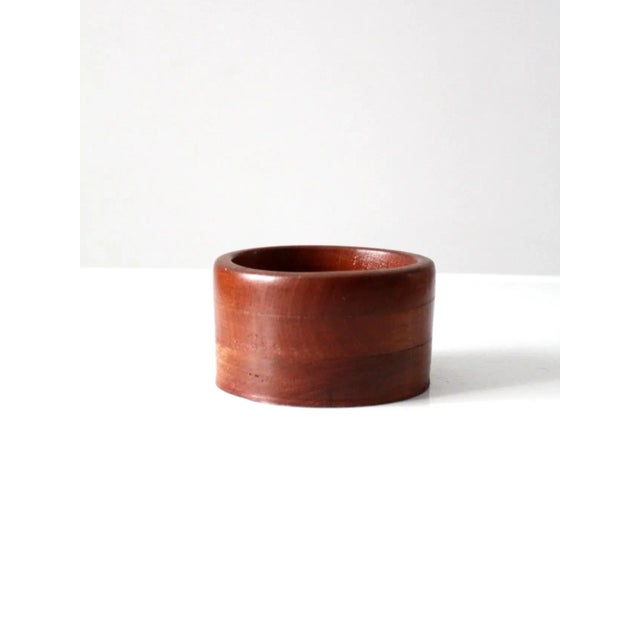 Vintage hand-crafted wooden bowl showcasing the natural beauty and variation of the wood grain. The simple, organic form...