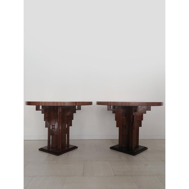 Set of two Art Deco tables or Gueridon tables with circular top in burl wood and sculptural feet in solid dark wood, made...