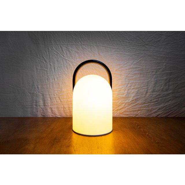 Table lamp with glass frame and metal handle. Tender model Designer: Lanciani Romolo Manufacturer: Tronconi 1980s I have...