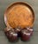 A set of five carved folk art apples in a dark wood, each unmarked with varying patinas and shapes. All on a round carved...