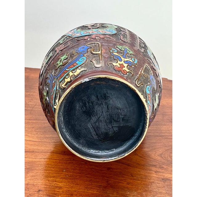 This exquisite antique champlevé urn exemplifies early 20th-century Japanese craftsmanship. The vibrant enamel inlays...
