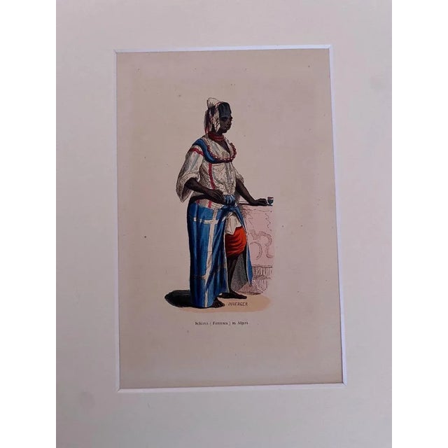 Algerian Woman is an original watercolor lithograph on paper realized in 1850 ca. by Anonymous Artist of 19th Century. In...