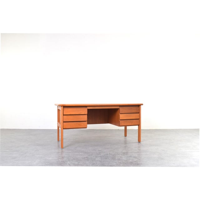 This freestanding Danish desk was made of solid teak, created in the 1970s. The furniture's design i san example of the...