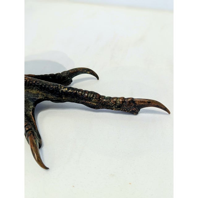 Sculptural bronze candlestick modeled as a bird of prey’s leg and talon. Dark patina with warm highlights. Mid-20th...