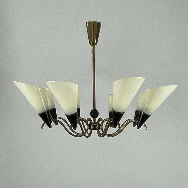This elegant mid-century chandelier was designed an manufactured in Finland in the 1950s to 1960s. The fixture features...