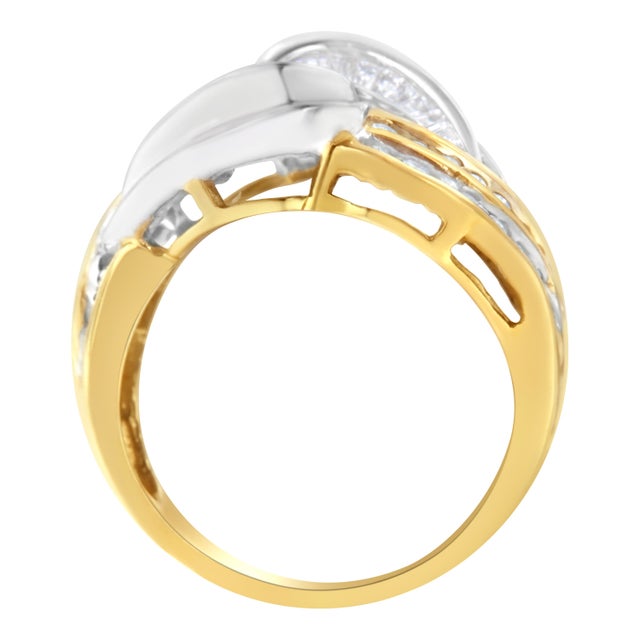 A unique gold and diamond bypass ring. This ring is made with 31 round and 52 baguette-cut diamonds in a channel setting....