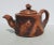 Handmade teapot in the style of Yixing with bark and tree-formed handles. Red clay with carved and impressed tree...