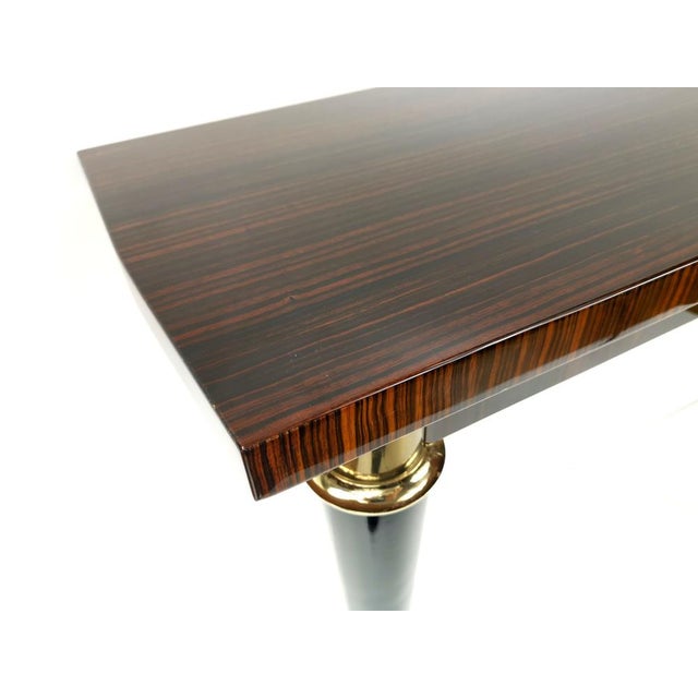 An elegant French console table from the 1960s, featuring a beautifully balanced mid-century design. The piece stands out...