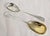 A fine pair of Edwardian sterling silver and gilt serving spoons dating to 1905, beautifully designed for serving berries,...
