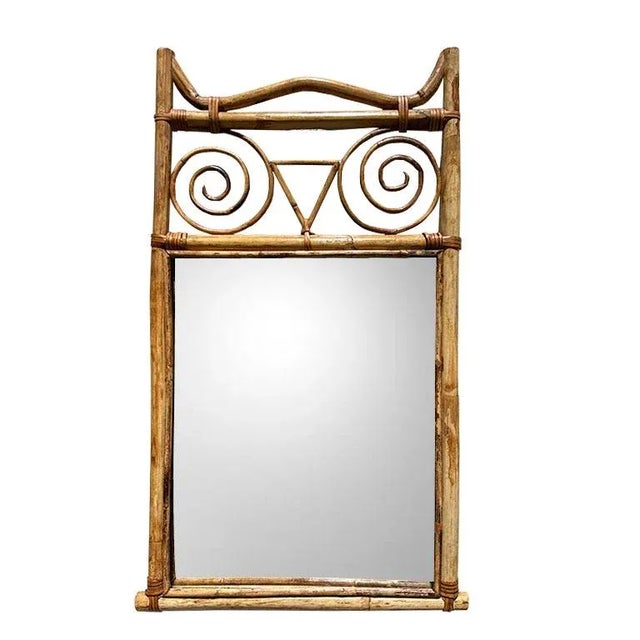 A gorgeous vintage burnt bamboo (or torched bamboo) scrolled hanging wall mirror. This piece will be fantastic in any...