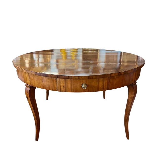 A handsome 19th century Italian walnut center table that also serves beautifully as a dining table. Crafted in rich...