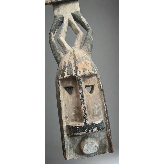 This Kanaga mask, emblematic of the Dogon culture of Mali, is carved from light wood then patinated with natural pigments....