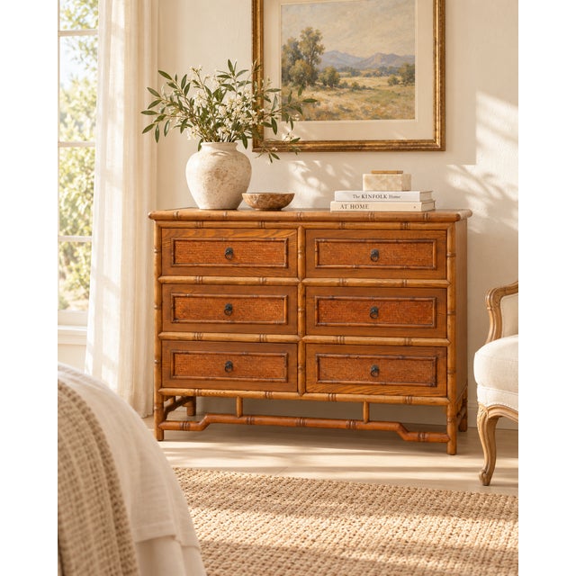 A wide six-drawer dresser, framed in the look of bamboo, with turned corner posts and rails and raised joints that mimic...