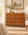 A wide six-drawer dresser, framed in the look of bamboo, with turned corner posts and rails and raised joints that mimic...