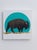 Green Sunset by Tammy Liu-Haller | Charcoal, pastel, ink, acrylic on encaustic panel with gold leaf Bison silhouette against a teal circle. For Sale