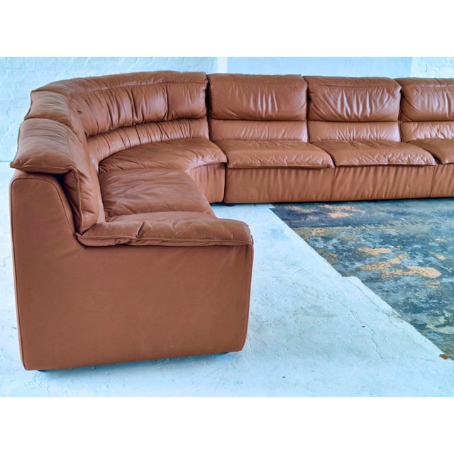 Large and impressive modular corner sofa produced in Italy during the 1970s, executed in cognac coloured leather with an...