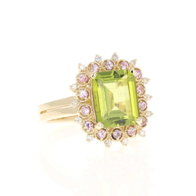 This beautiful ring has an Emerald Cut Peridot that weighs 3.30 Carats. The ring is surrounded by 14 Pink Sapphires that...