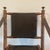 Faux bamboo and brown leather folding chair from the 20th century with sling arms.