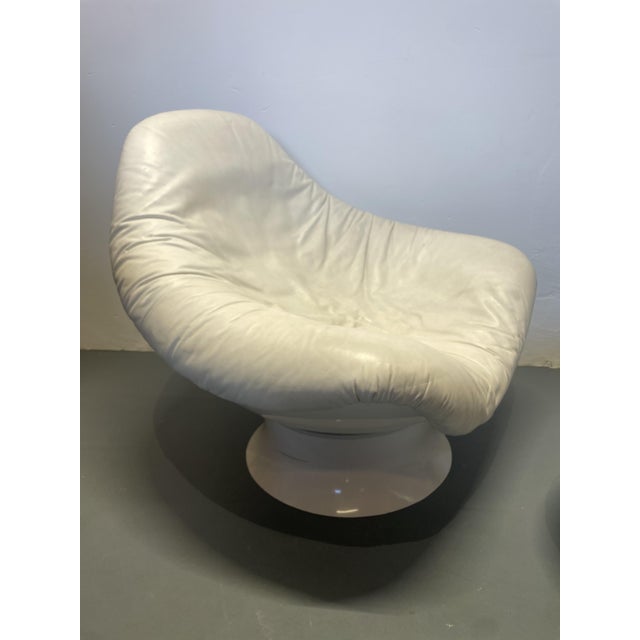 Rodica armchair and footstool by Mario Brunu for Comfort, Italy, from the 1960s. The armchair's seat shell rests on the...