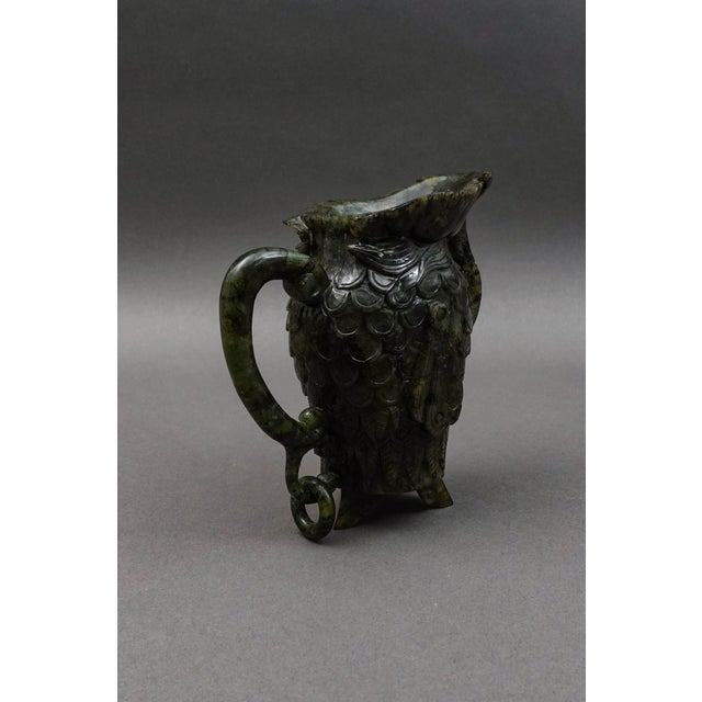 Chinese Carved Spinach Jade Carved Small Handled Pitcher. Measures approximately 5 1/2" long, 2 1/2" wide, 5 7/8" high.