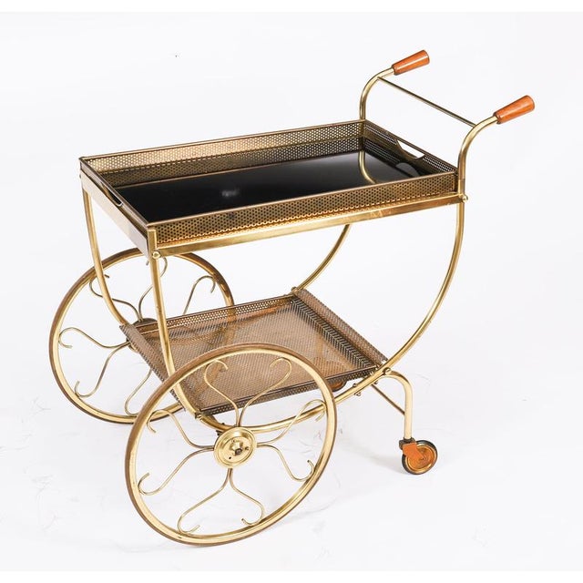 This is a very entertaining vintage two tier brass French drinks trolley, mid-century, 1950s in date. It has a scroll push...