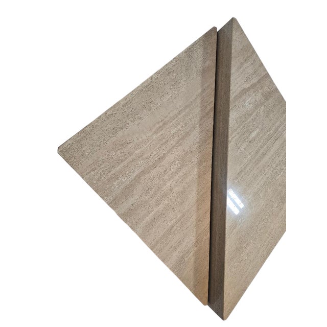 This oversized geometric travertine coffee table features a striking split-plane design with a sloped top surface and...
