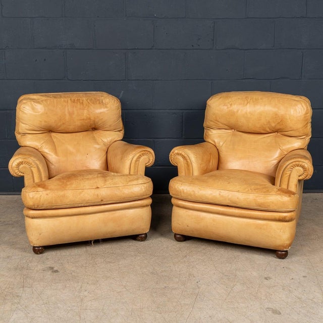 A handsome pair of italian armchairs produced by poltrona frau in the 1970s, upholstered in original tan leather with a...