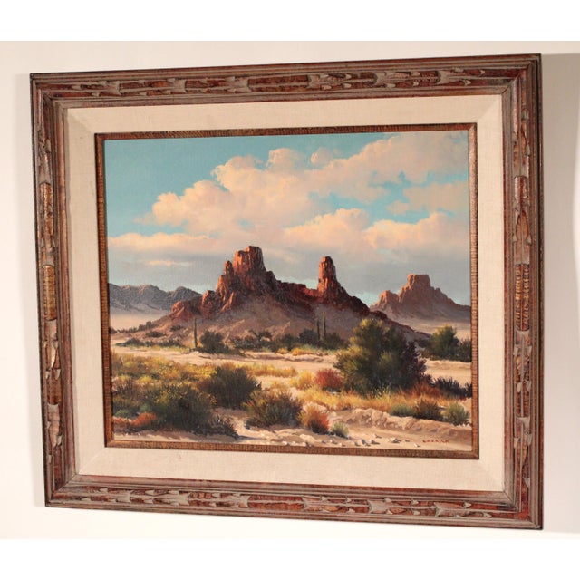 Southwestern desert landscape painting with red rocks by Beverly Carrick (born 1930). Oil on canvas. Frame dimensions,...