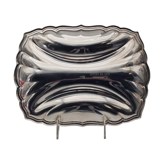 This three-section relish dish was produced by Reed & Barton and executed in a Chippendale-inspired form. Crafted in...